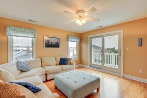 a living room with a couch and a ceiling fan at Long Beach Island Townhome with Rooftop Deck! in Long Beach