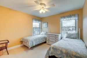 a bedroom with two beds and a ceiling fan at Long Beach Island Townhome with Rooftop Deck! in Long Beach