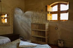 a room with a bed and a window and a shelf at Handeleya House 