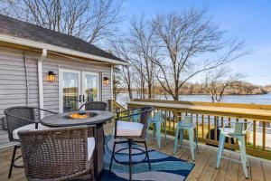 a patio with a table and chairs on a balcony at Hilltop Lakehouse - Free Kayaks Deck PLX in Akron
