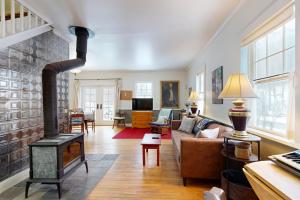 a living room with a wood stove at The Daydream Cottage in Woodstock