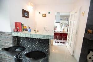 a bathroom with two stools and a counter with a sink at Habitacion con dos camas dobles y baño propio in Puebla +25 photos