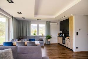 a living room with a couch and a table at Apartamenty TRIO in Muszyna