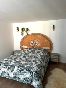 a bedroom with a bed with a floral bedspread at L’Usine in Concarneau