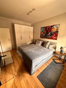 a bedroom with a bed and a painting on the wall at Haus mit 2 schönen Studio Appartements in Würselen