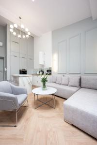 a living room with a couch and a table at Native Apartments Starowiślna 43/16 in Krakow