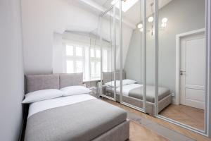 a bedroom with a bed and a mirror at Native Apartments Starowiślna 43/16 in Krakow