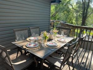 un tavolo con piatti e bicchieri su un ponte di Sweet Cottage near Downtown DSM a Des Moines