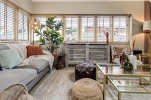 a living room with a couch and a table at Walk to Marlowe Theatre from our lovely flat in the city centre in Canterbury +16 photos