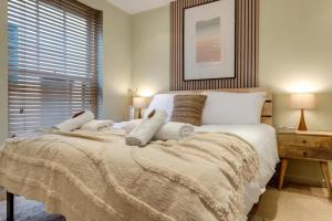 a bedroom with a large bed and a window at Walk to Marlowe Theatre from our lovely flat in the city centre in Canterbury