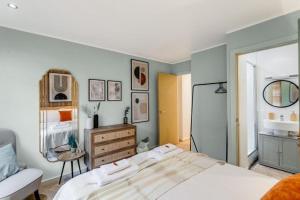 a bedroom with a bed and a dresser in it at City Stays Luxury Townhouse in Canterbury, sleeps 6 in Canterbury