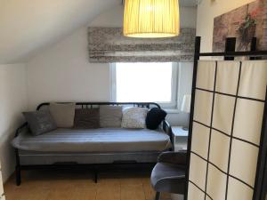 a living room with a couch and a window at Mazurska Riwiera in Dabrowa