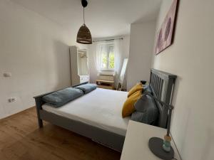 a bedroom with a bed and a table and a chair at Rosmarin Apartments Sea View Garden Side in Jadranovo