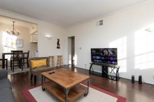 a living room with a table and a tv at One bedroom one bath apartment in Hollywood in Los Angeles