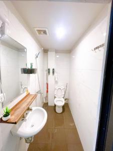 a bathroom with a white toilet and a sink at Promotion Quoc Tu Giam 202 in Hanoi