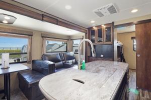 a rv living room with a table and a couch at Sunshine Key RV Resort & Marina in Big Pine Key