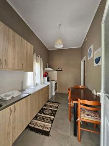 a kitchen with a table and a dining room at House with yard in Alykes Potamou