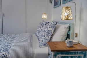 a bed with blue and white pillows and a table at BALCÓN DEL ATLÁNTICO in Garachico