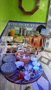 a table filled with plates and bowls of food at Auberge Cascade Imilchil in Imilchil