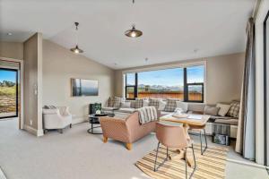 a living room with a couch and a table at Peaceful Retreat - Hawea Flat in Hawea Flat