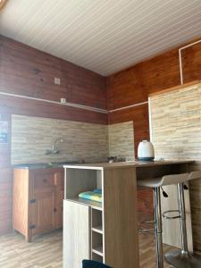 a kitchen with wooden walls and a counter top at Complejo Nueva Luna in La Coronilla