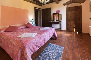 a bedroom with a large bed and a table at Casa del Lecceto in Campiglia Marittima