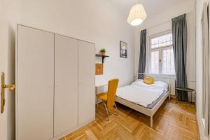 a small bedroom with a bed and a desk at Downtown Rooms Wesselenyi in Budapest