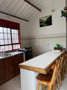a kitchen with a counter and a sink and a table at Villa Ocampo in Salento