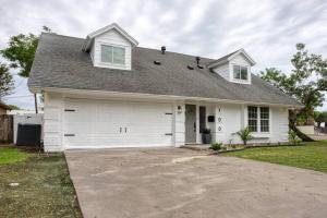 a white house with a large garage at Your Seaside Sanctuary on Ocean Drive Awaits in Corpus Christi