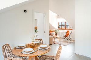 a dining room with a table and chairs at Villas de La Ribera in Suances