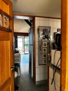 a kitchen with a refrigerator in a room at Casa de las Chacras 2 in San Carlos de Bariloche