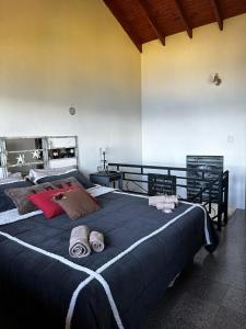 a bedroom with a large bed with towels on it at Casa de las Chacras 2 in San Carlos de Bariloche