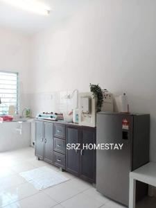 a kitchen with a sink and a counter in a room at Srz Homestay Teluk Kemang PD in Port Dickson