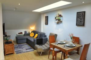 a living room with a couch and a table at Top Floor Apartment in Islington in London