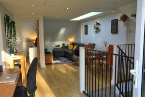 a living room with a couch and a table at Top Floor Apartment in Islington in London