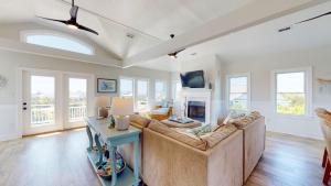 a living room with a couch and a fireplace at Sundancer in Southport