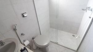 een badkamer met een douche, een toilet en een wastafel bij Opera Hostel in Curitiba