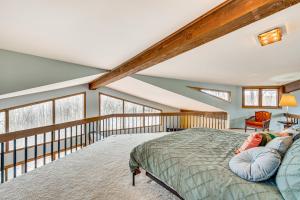 a bedroom with a bed and a balcony at Eclectic Hubertus Home with Game Room and Fire Pit! in Germantown