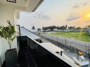 a balcony with a table and a view of a field at WHITEFIELD LUXURY APARTMENT in Orimedu