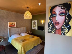 a bedroom with a bed and a painting of a woman at Hotel Stadsherberg Sneek in Sneek