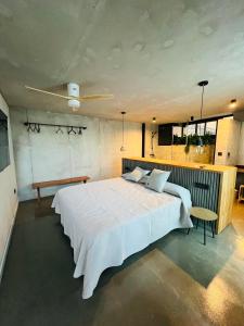 a bedroom with a large white bed and a ceiling at Villa Salitre in Costa de Antigua +29 photos