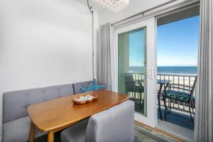 a dining room with a table and a view of the ocean at Direct Oceanfront Studio Suite! in Hampton