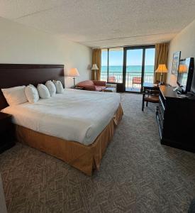 a hotel room with a bed and a view of the ocean at Best Western Ocean Sands Beach Resort in Myrtle Beach
