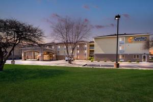 a hotel with a parking lot in front of a building at Comfort Inn & Suites Springfield I-55 in Springfield