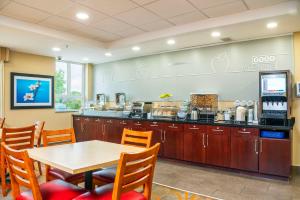a restaurant with a table and chairs and a counter at Comfort Inn & Suites in Kincardine