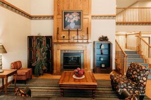 a living room with a fireplace and a table at Country Inn & Suites by Radisson, Lancaster Amish Country , PA in Lancaster