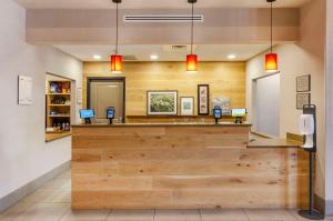 a cashier counter in a dental office with wood at Country Inn & Suites by Radisson, Charlottesville-UVA, VA in Charlottesville