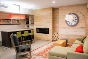 a living room with a clock on the wall at Country Inn & Suites by Radisson, Richmond West at I-64, VA in Richmond