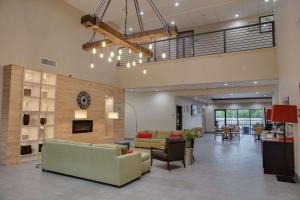 a large living room with couches and a fireplace at Country Inn & Suites by Radisson, Harlingen, TX in Harlingen