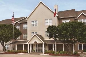 un edificio con dos banderas delante en Country Inn & Suites by Radisson, Lewisville, TX, en Lewisville